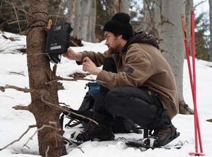 A Volunteer checking a trail camera